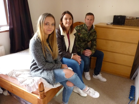 Cassie with her husband Lee and daughter Jordan in the box where they lived together for two years